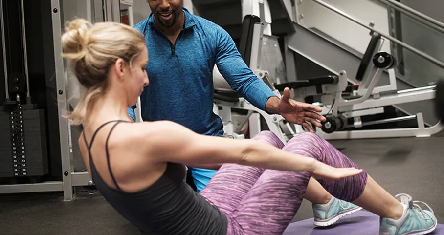 Personal trainer helping client